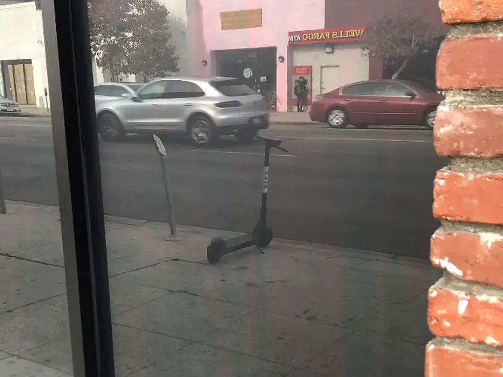 A shopfront window restored to clear, protected by film that takes the next hit.